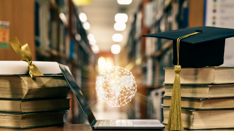 Books and a graduation cap with a symbol of artificial intelligence