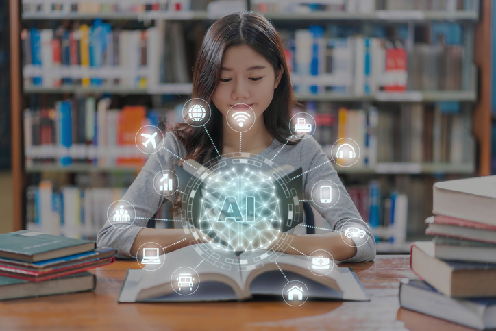 A girl sitting at her desk with an artificial intelligence icon over her book.